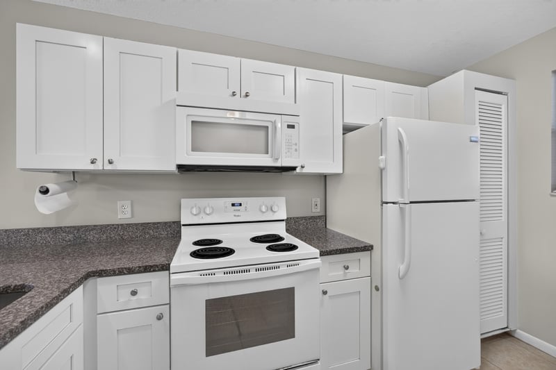 Kitchen with microwave, range, and refrigerator at 700 W Pope Rd unit h61, St. Augustine, FL 32080
