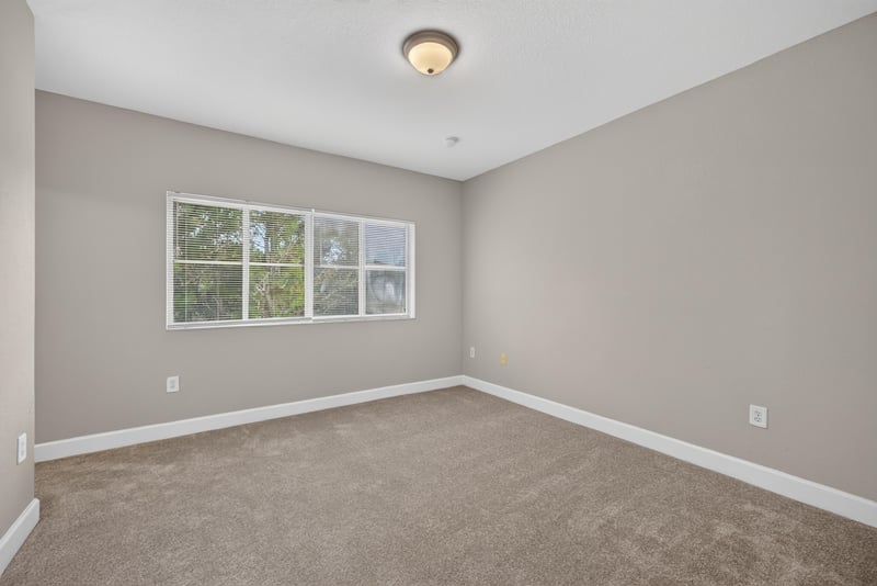 Carpeted bedroom with window at 9745 Touchton Rd, Jacksonville, FL 32246