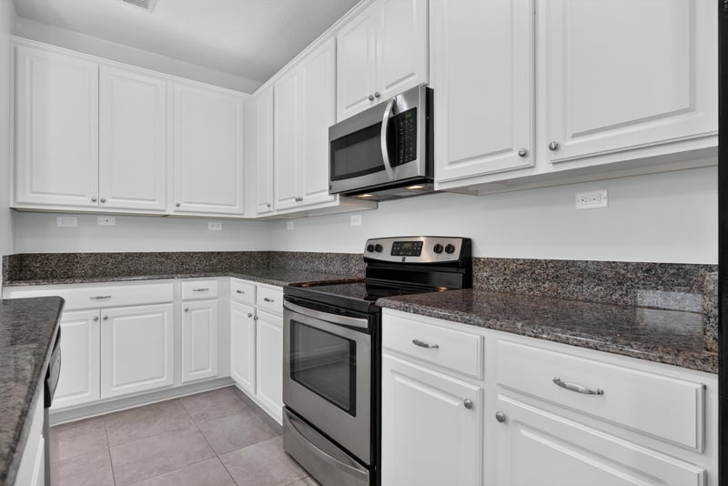 Kitchen counter and range with granite countertops at 2378 Caney Oaks Dr, Jacksonville, FL