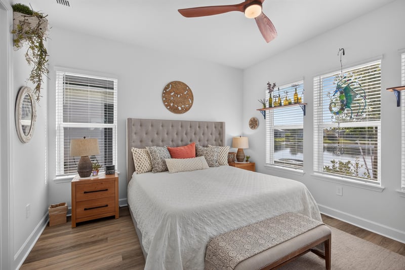 Bedroom with upholstered bed and two windows at 129 Amberwood Dr, St. Augustine, FL