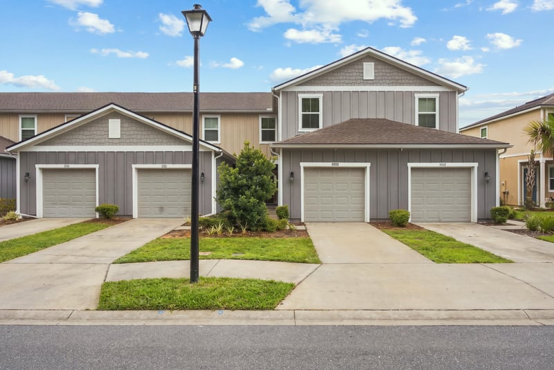 Front elevation showing garages and matching facades at 9555 Star Dr, Jacksonville, FL 32256
