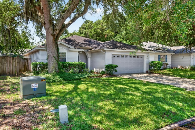 Front exterior view across lawn toward garage at 1108 Hidden Cove Cir S, Atlantic Beach, FL 32233
