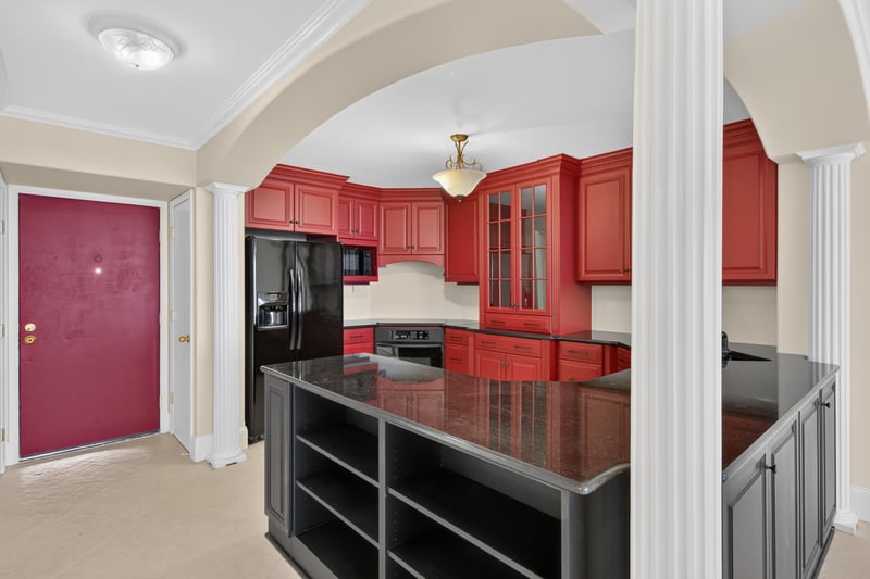 Kitchen with red cabinets and black granite island at 1301 1st St S