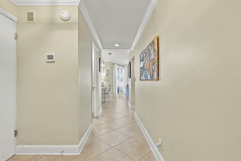Entry hallway with tile floor and wall art at 805 Spinnakers Reach Dr, Ponte Vedra Beach, FL 32082