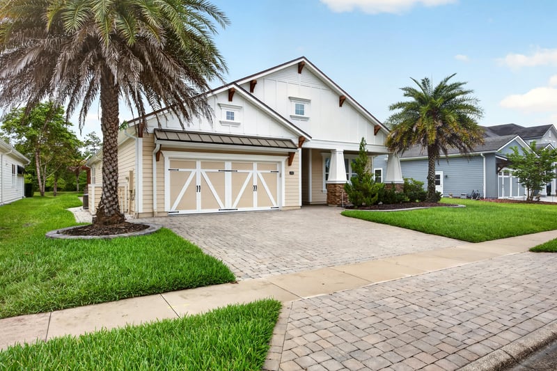 Front exterior with pavered driveway and palm trees at 186 Freshwater Dr