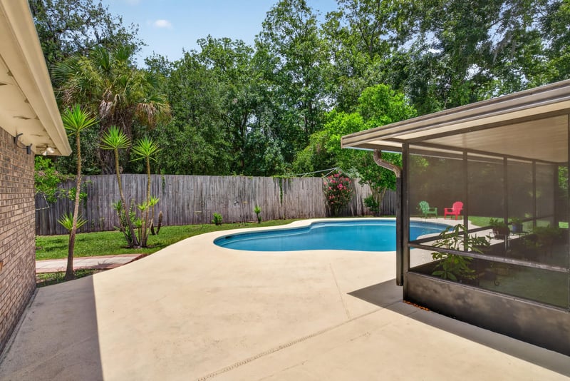 Backyard pool with screened lanai at 12810 Swamp Owl Ln