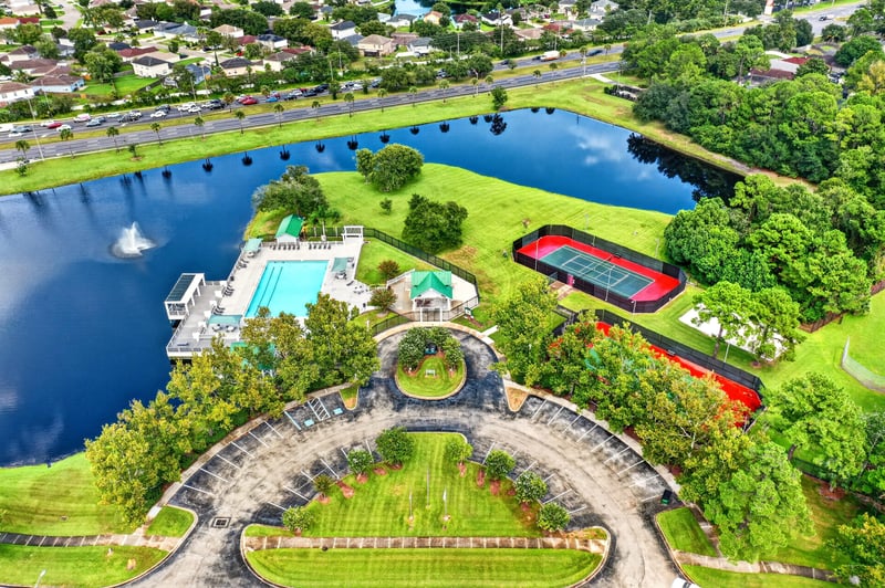 Aerial view of community pond, pool, and tennis courts in Jacksonville, FL