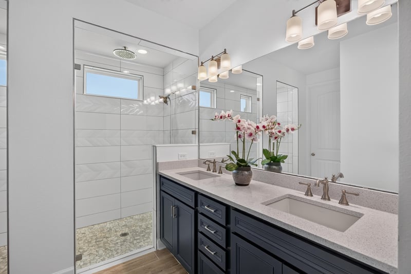 Primary bathroom with double vanity and glass shower at 855 Flach Dr, St. Johns, FL