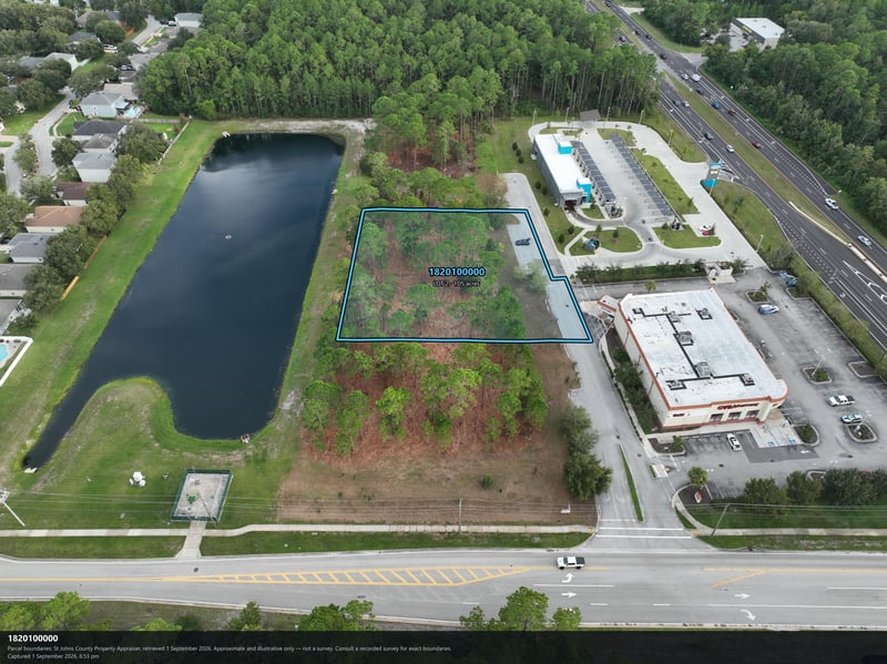 Aerial view of the pond and commercial building near the lot at 4900 US-1, St. Augustine, FL 32086