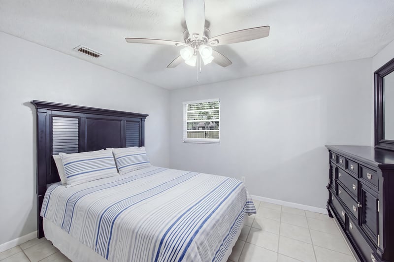 Bedroom with dark bed frame and window at 417 Capricorn Ln, Orange Park, FL 32073