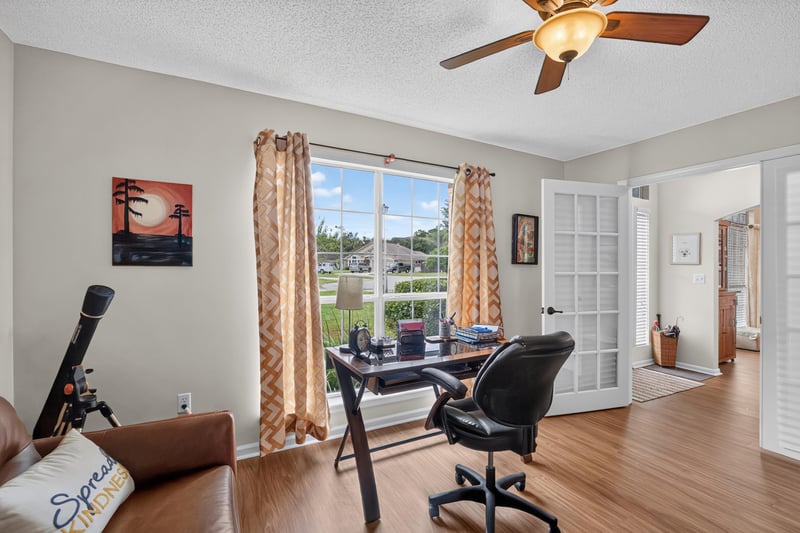 Home office with desk and window view of yard at 13514 Las Brisas Way N, Jacksonville, FL