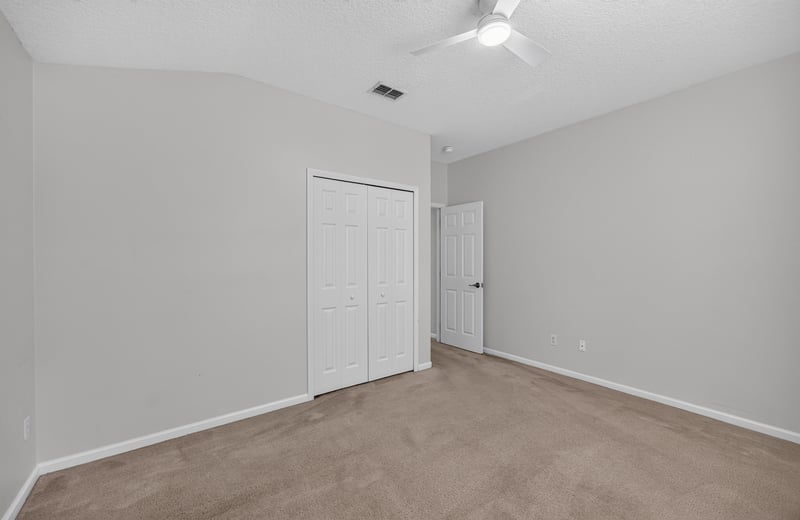 Empty room with closet doors and carpet at 2480 Ridge Will Dr, Jacksonville, FL 32246