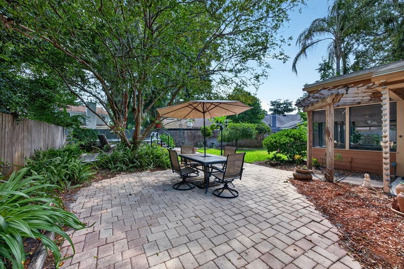 Backyard patio with pavers and table at 4837 Pareja Ct, Jacksonville, FL 32225