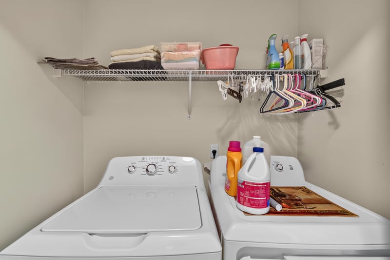 Laundry room with washer, dryer and wire shelving at 13514 Las Brisas Way N, Jacksonville, FL