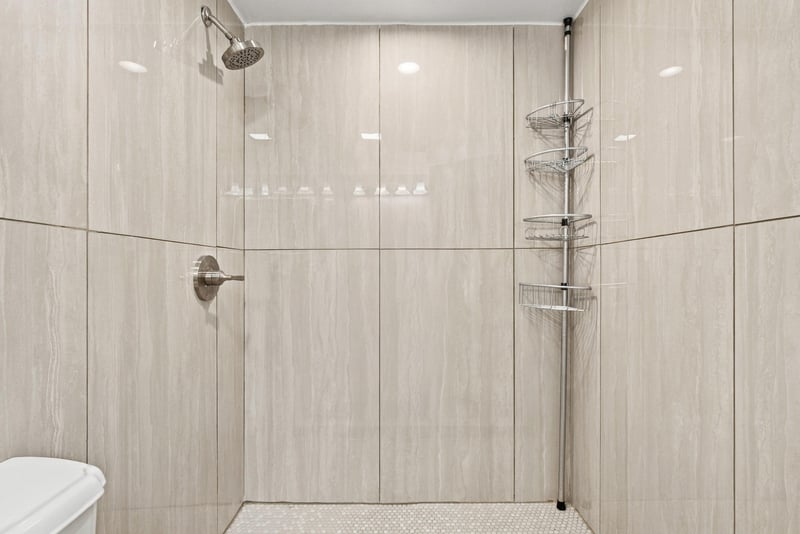 Tiled shower with glass enclosure at 7703 Las Palmas Way