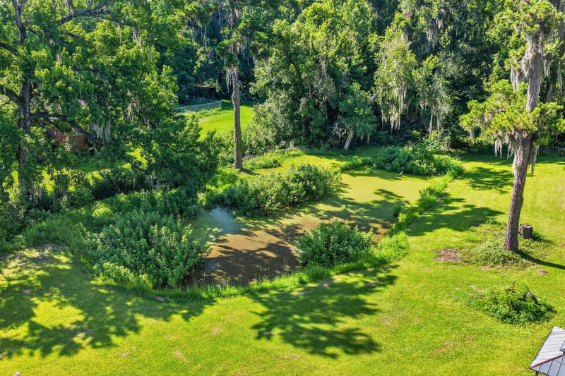 Side yard with mature trees at 5745 110th St, Jacksonville, FL 32244