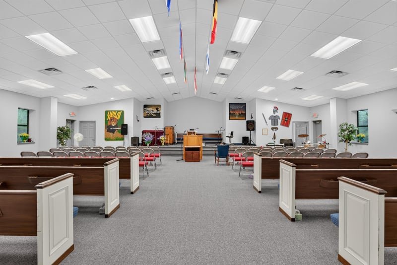 Assembly hall with wood pews and ceiling flags at 1038 County Rd 315, Melrose