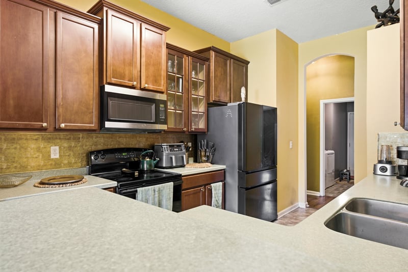 Kitchen with black range and microwave at 7392 Timber Falls Ct