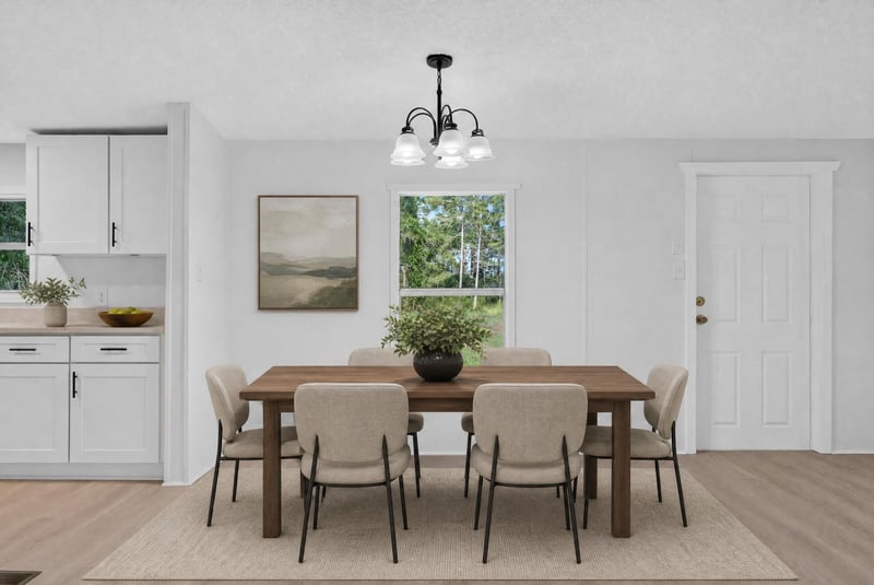 Virtually staged dining area with table and chandelier at 55520 Jewel-Thomas Rd, Callahan, FL 32011