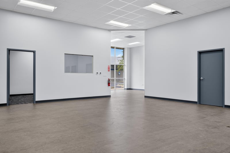 Open interior space with side door and exterior window at 7240 Golden Wings Rd building 100, Jacksonville, FL 32244