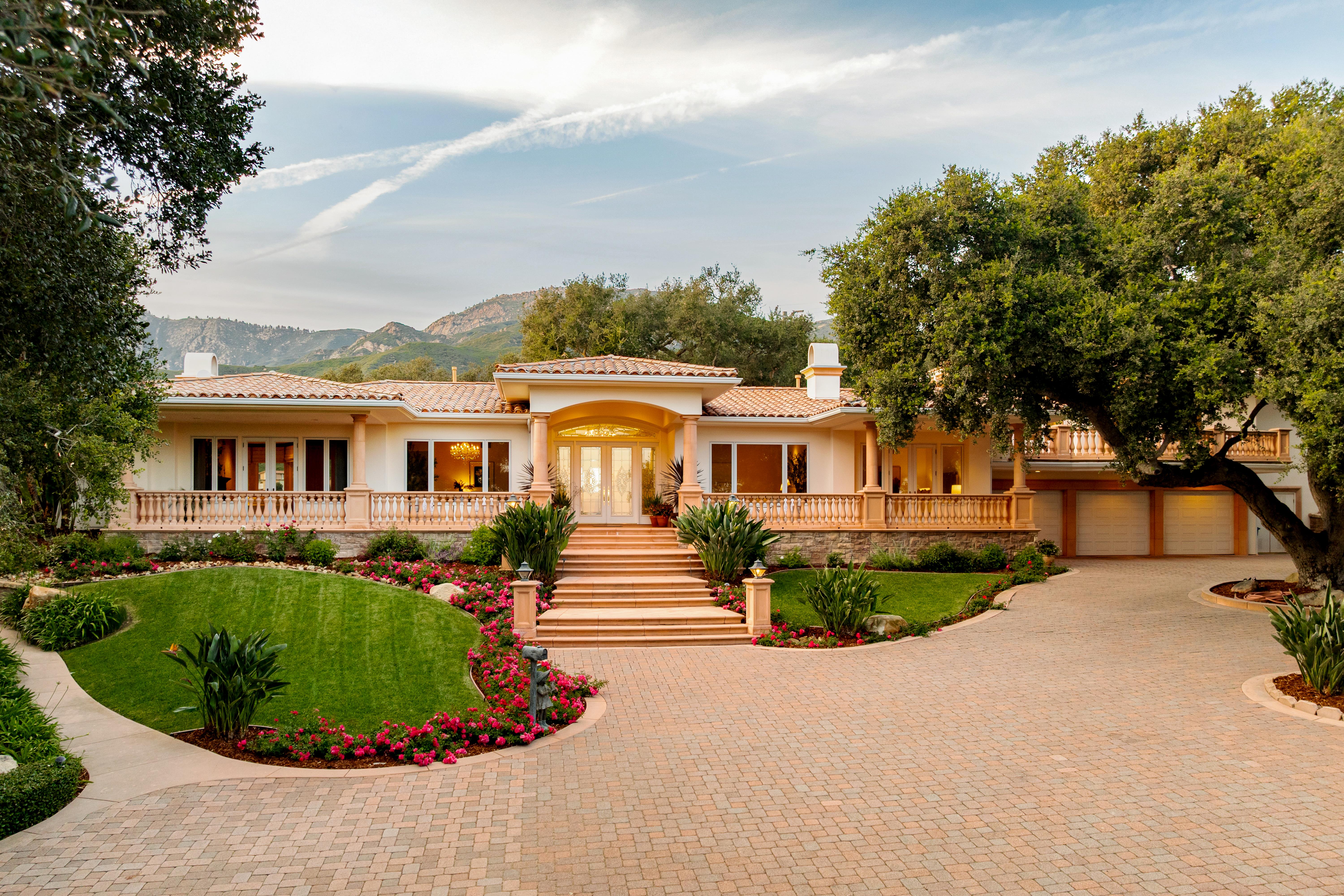 Twilight photography of estate exterior at 450 El Cielito Rd, Santa Barbara — virtual tour photography and twilight imaging capturing warm interior light against a violet Pacific sky above the American Riviera. Our team captured still photography, aerial drone photography, twilight photography, a Matterport virtual tour, a 2D floor plan, and a custom property website from afternoon through twilight.