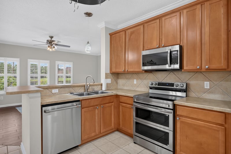 Kitchen with stainless appliances and wood cabinets at 1493 Greyfield Dr, St. Augustine, FL 32092