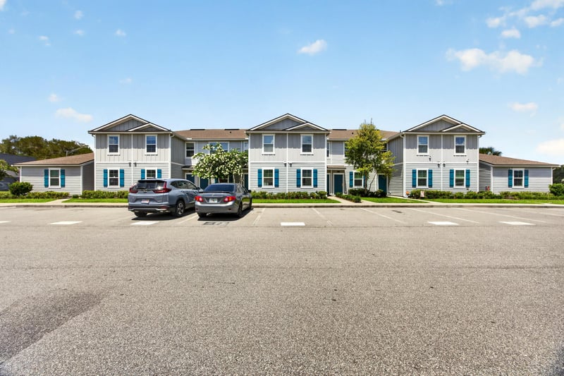 Street view of attached townhomes and parking in Jacksonville, FL