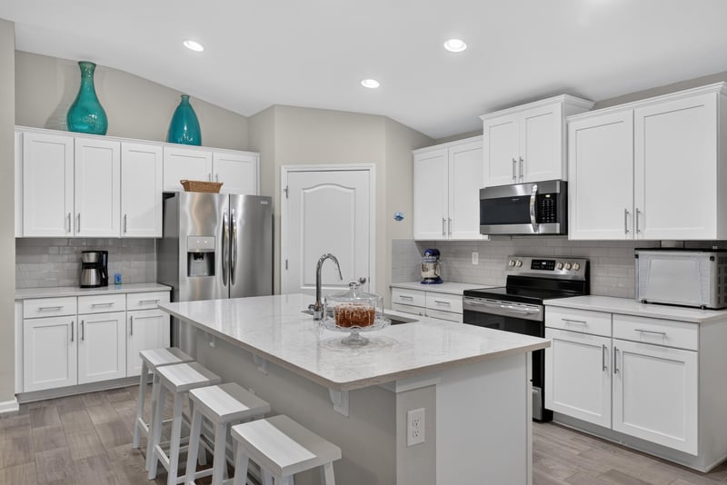 Kitchen with stainless appliances and island seating at 4319 Green River Pl, Middleburg, FL 32068