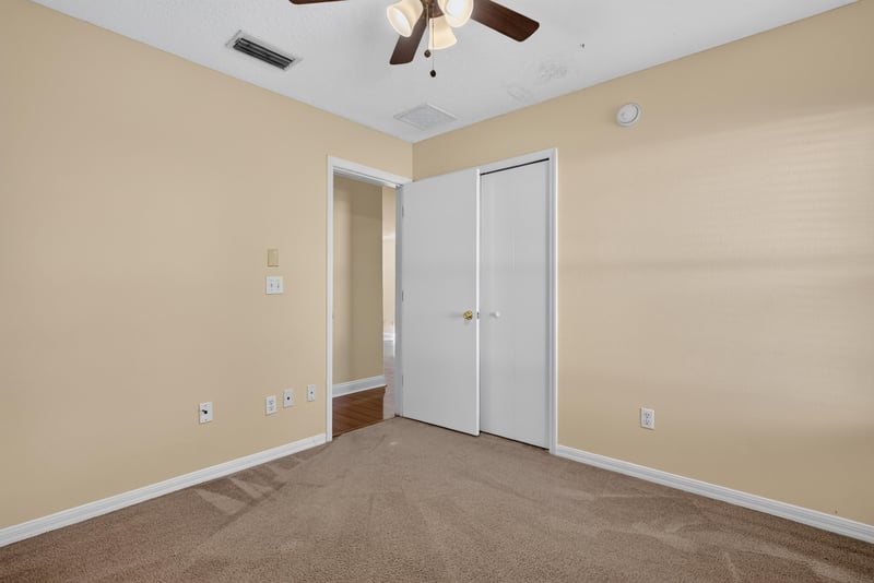 Empty room with closet doors and carpet at 353 Redwood Ln
