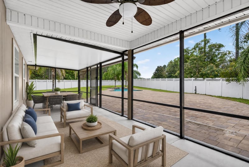 Screened porch with seating area at 706 Grampian Highlands Dr, St. Johns, FL 32259