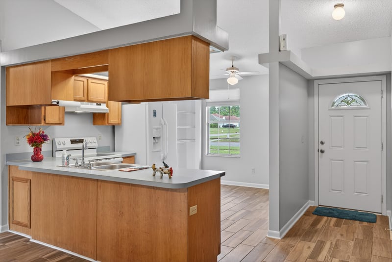 Kitchen with cabinets and side entry door at 2164 Orangewood St, Middleburg, FL 32068