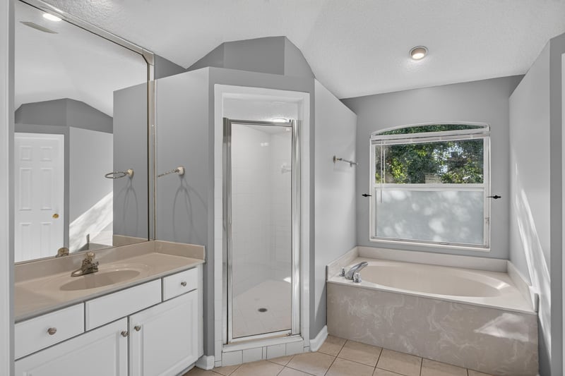Primary bath with garden tub and glass shower at 470 Sparrow Branch Cir, Jacksonville, FL 32259