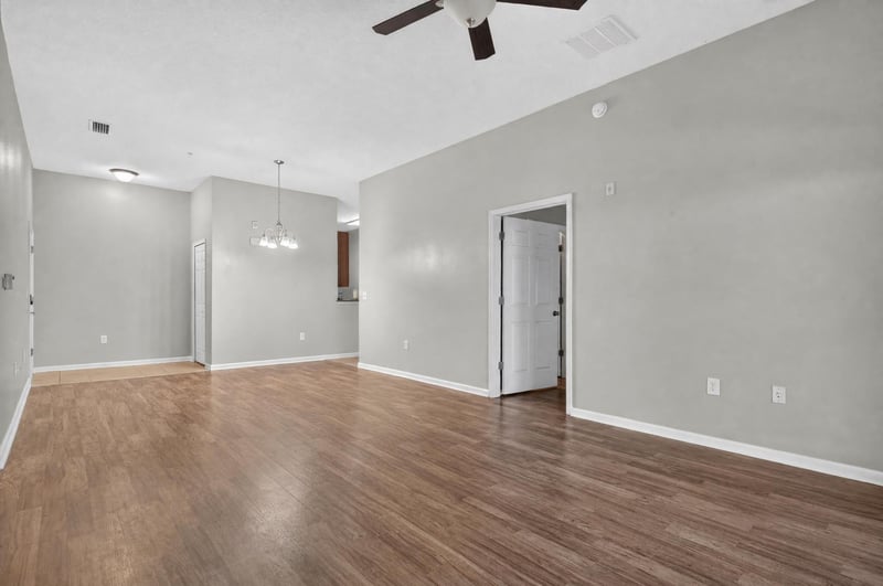 Open living space leading to hallway doors at 8196 Cabin Lake Cir, Jacksonville, FL 32256