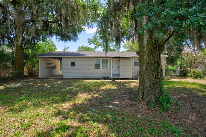 Backyard view with shaded lawn at 855 Cornwallis Dr, Jacksonville, FL
