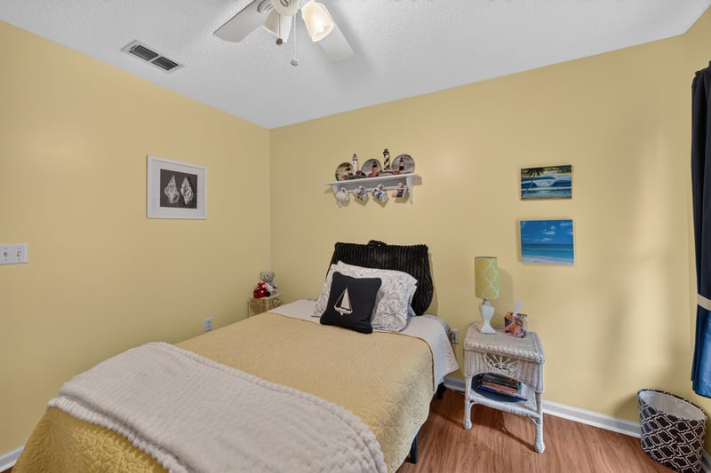 Bedroom with twin bed and yellow walls at 13514 Las Brisas Way N, Jacksonville, FL
