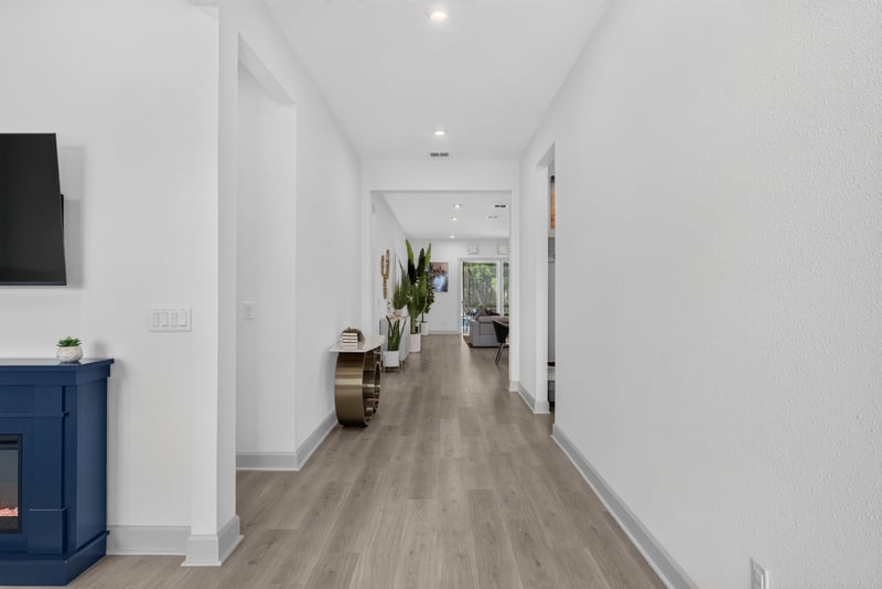 Hallway with wood-look flooring leading to living areas at 785 Back Creek Dr, St. Augustine, FL 32092