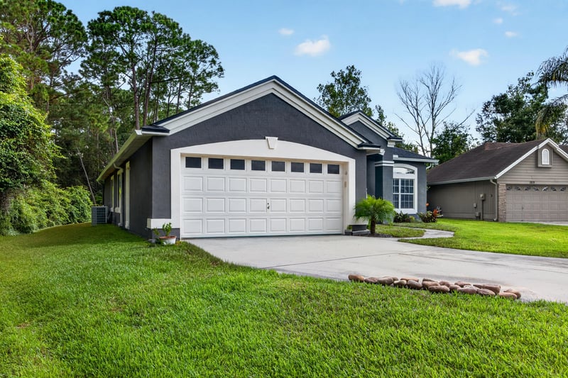Front exterior viewed from across the street at 1820 Burgess Hill Dr E, Jacksonville, FL