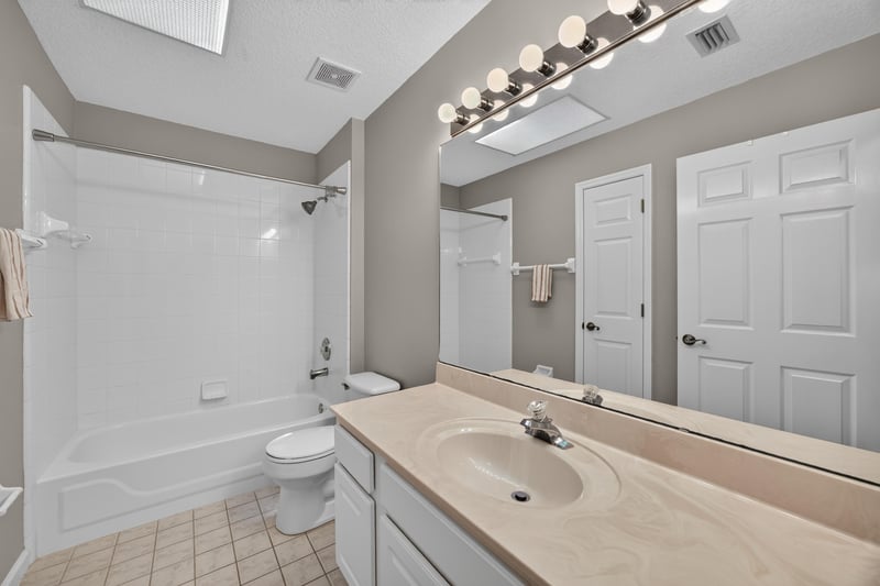 Bathroom with tub and mirror at 1955 GUARDED Way, Fleming Island, FL 32003