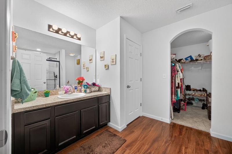 Primary bathroom with dark wood double vanity at 518 Matecumbe Ct, Macclenny, FL