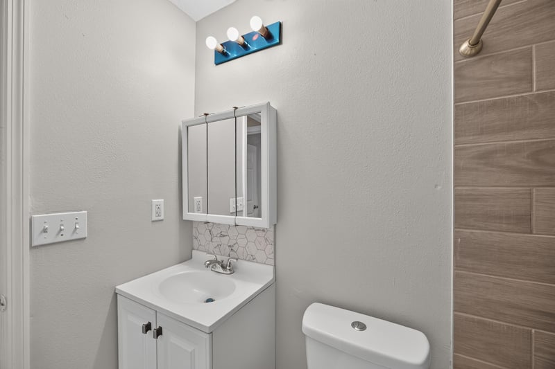 Bathroom vanity and toilet at 7015 Miss Muffet Ln N, Jacksonville, FL 32210