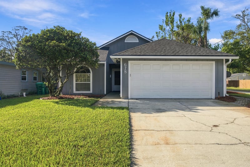 Front exterior with driveway and garage at 678 5th Ave N, Jacksonville Beach, FL 32250