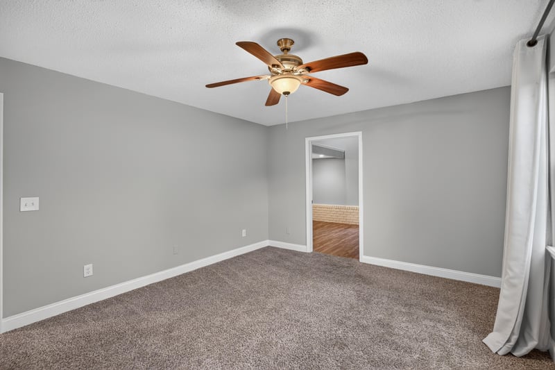 Carpeted bedroom with curtains at 12344 Cormorant Ct, Jacksonville, FL