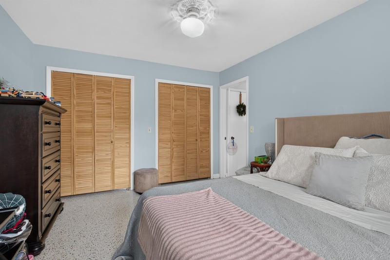 Bedroom with double closets and bed at 5745 110th St, Jacksonville, FL 32244