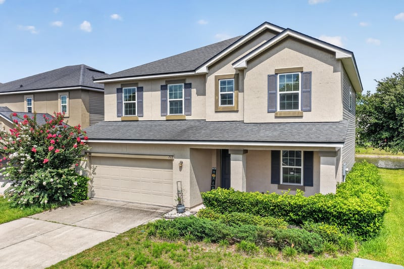 Front exterior view showing shutters and landscaped entry at 263 Gilmore Ln, Orange Park, FL 32065