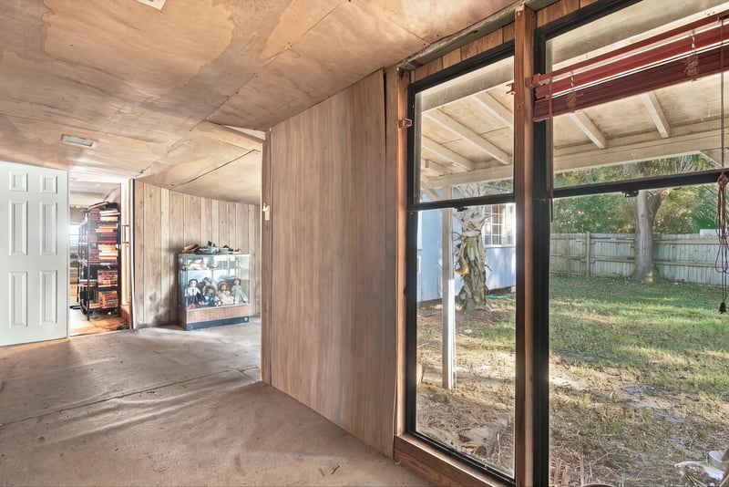 Sunroom with wood paneling and large windows at 1807 Idlewild Ave, Green Cove Springs, FL