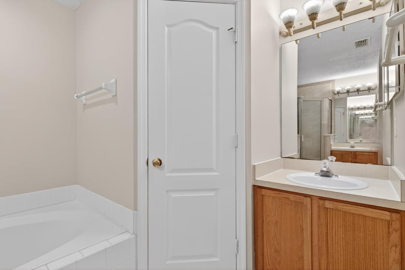 Bathroom with double closet doors and vanity at 1648 Glen Laurel Dr, Middleburg, FL 32068