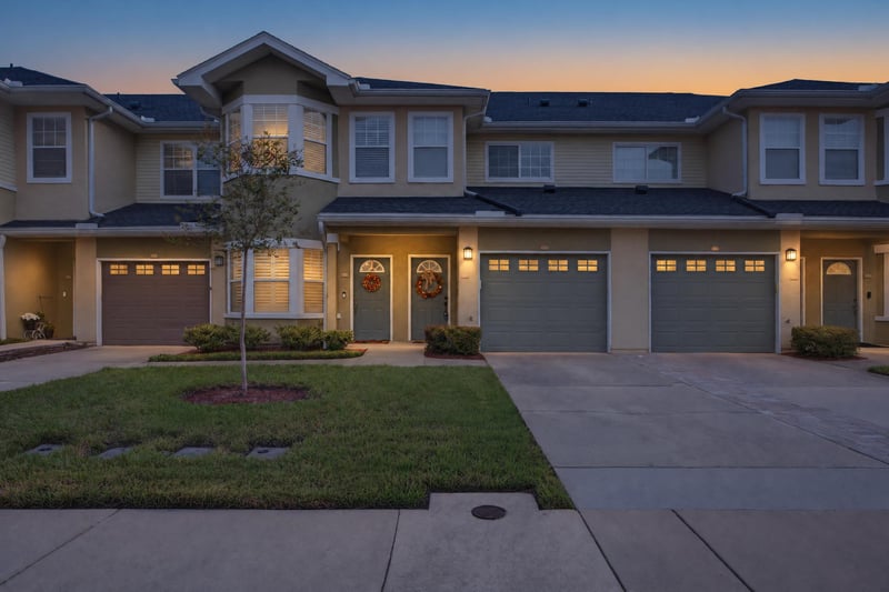 Front exterior at day-to-dusk with lit windows at 3750 Silver Bluff Blvd, Orange Park, FL