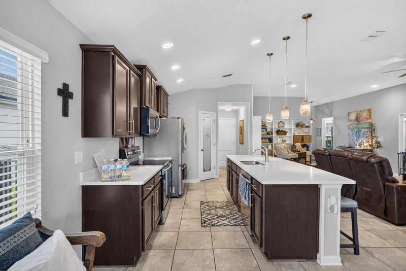 Kitchen view toward living room with pendant lights at 589 Seville Pkwy, St. Augustine, FL