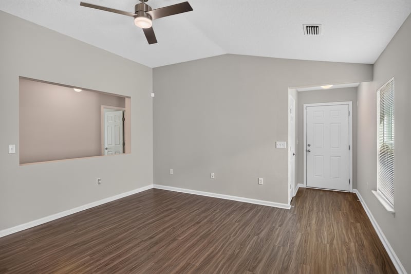 Empty room with ceiling fan and entry door at 7118 Preston Pnes Trl, Jacksonville, FL