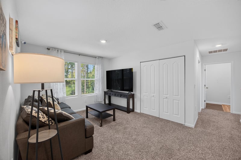 Bonus room with seating and closet doors at 65255 Frst Glen Ln, Yulee, FL 32097